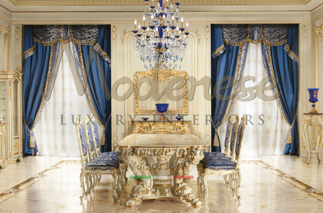 Blue fabric curtains in Modenese dining room with white hand carved table and blue pattern fabric chairs