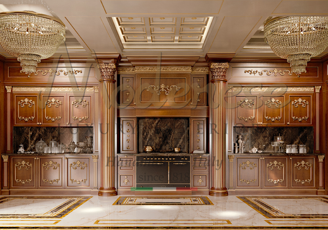 Classic walnut Modenese Luxury Interiors kitchen with dark marble and gold leaf details two chandeliers and columns