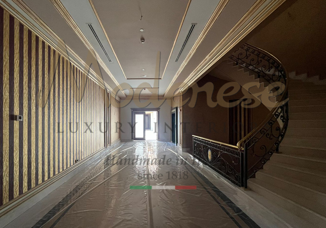 Corridor with stairs and doors gold leaf details Modenese interiors