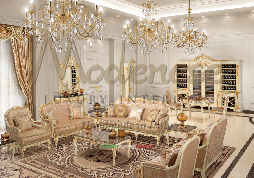 Light pink fabric sofas and armchairs white and gold leaf wine cellar cabinets and 3 chandeliers