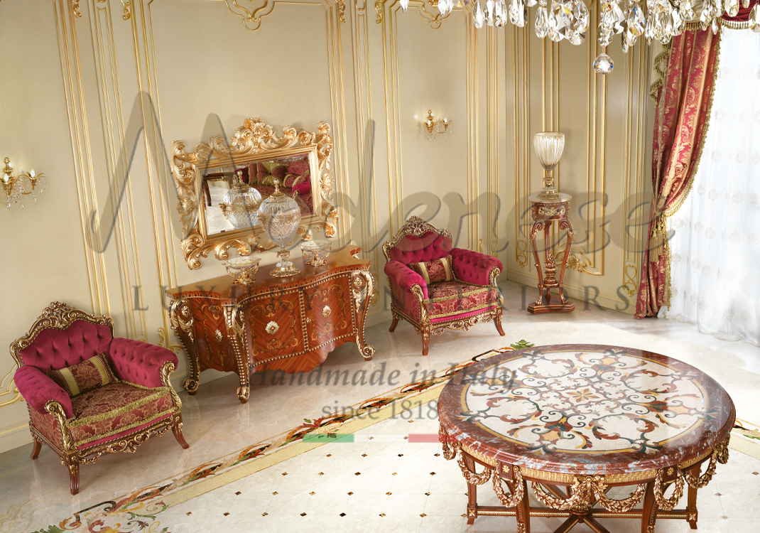 Modenese red fabric armchairs walnut sideboard with gold leaf details hand carved gold leaf mirror round table with hand carved gold leaf decorations and inlaid marble top