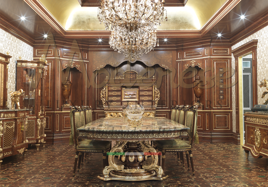 Modenese dining room with hand carved inlaid marble table and gold leaf details green fabric chairs chandeliers and walnut walls decoration